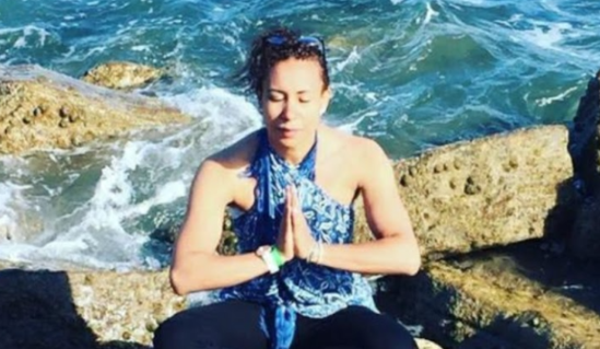 Gisele in a peaceful Reiki meditation beside the sea